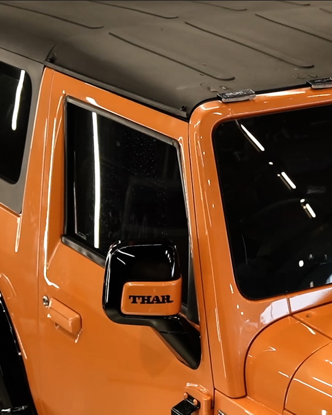 High-quality image of a premium Autostarke Edition Mahindra Thar, showcasing a custom Lava Orange ex