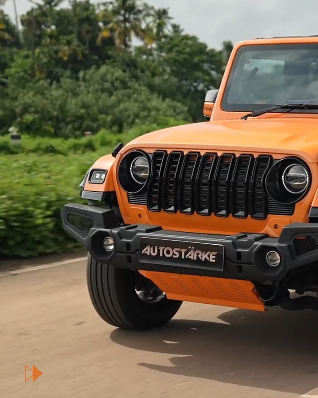  Front three-quarter view of the exclusive Autostarke Edition Mahindra Thar in Lava Orange, highligh